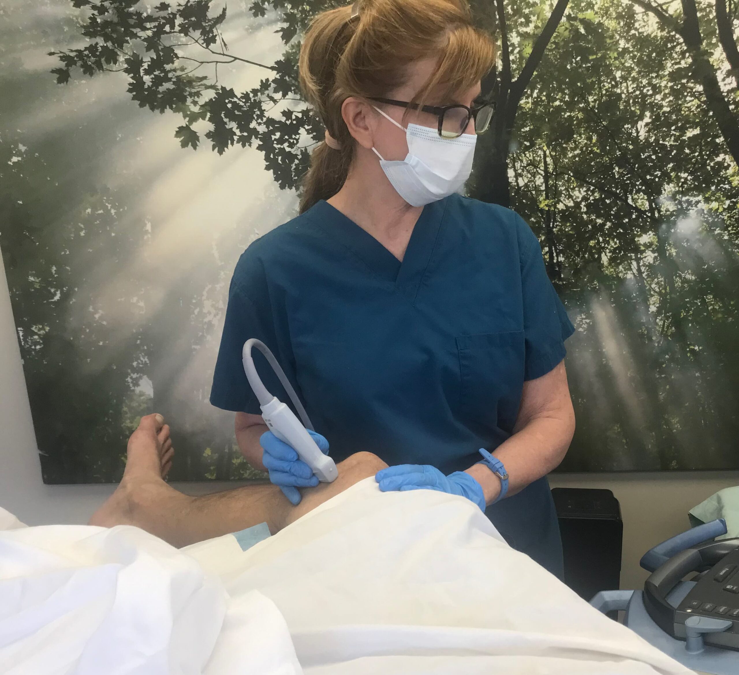 Gloria Tucker, M.D. using Ultrasound for PRP on knee joint for enhanced visibility.